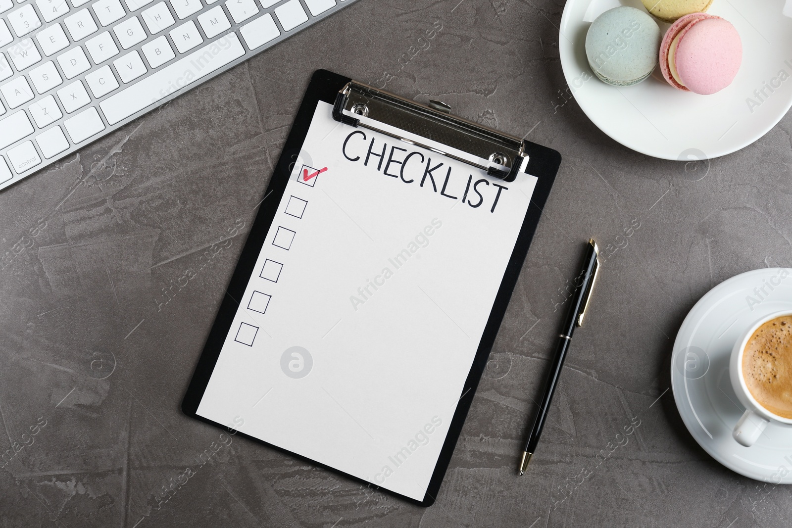 Photo of Clipboard with inscription Checklist, cup of coffee, computer keyboard and macarons on grey table, flat lay