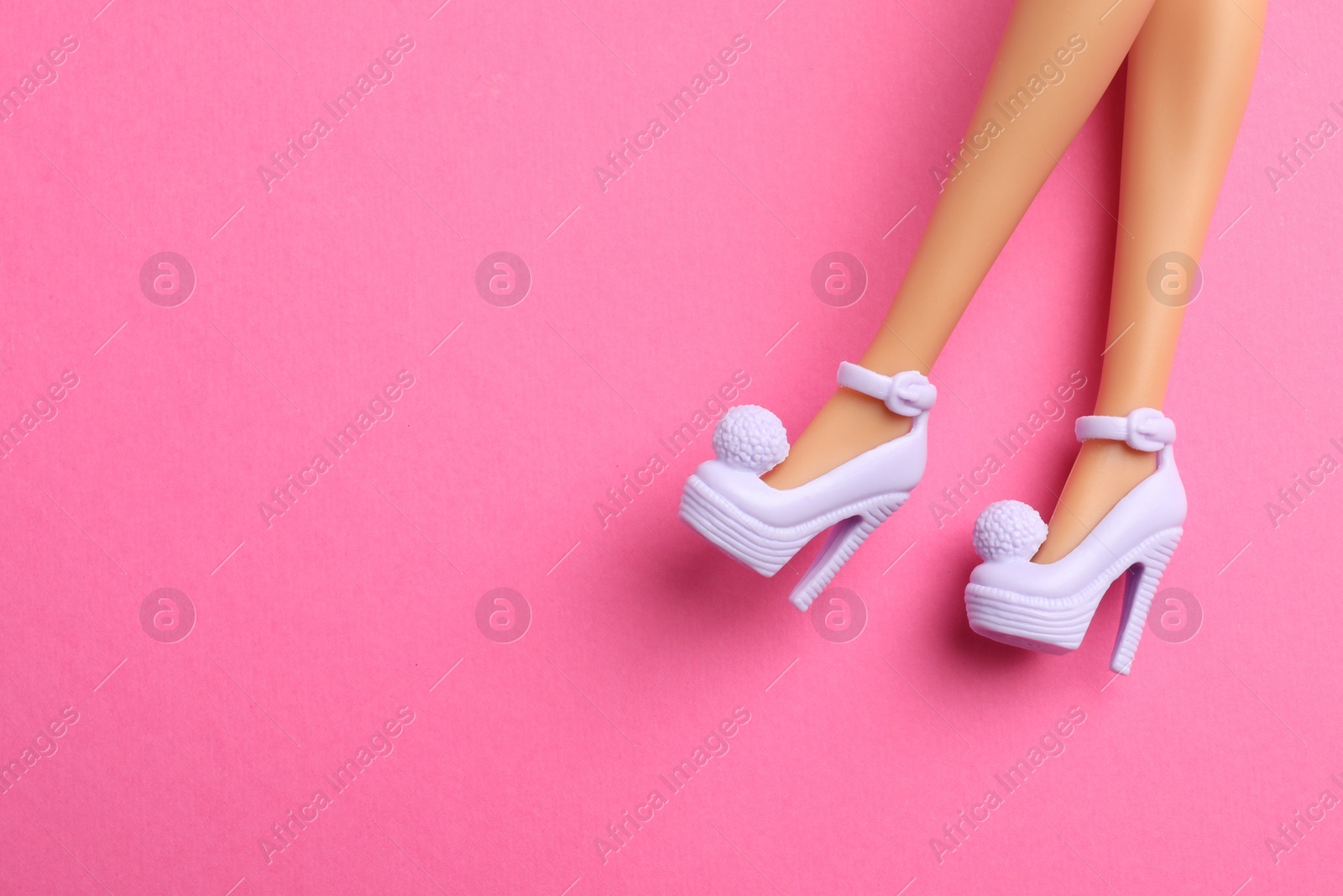 Photo of Mykolaiv, Ukraine - September 4, 2023: Barbie doll wearing beautiful heels on pink background, closeup. Space for text