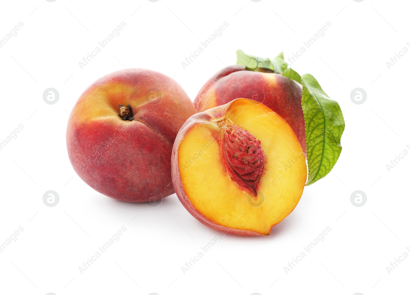Photo of Whole and cut ripe peaches with leaves isolated on white