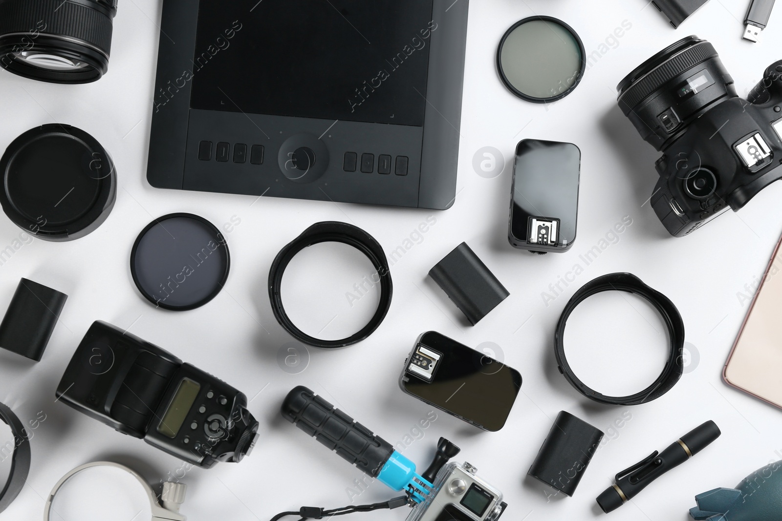 Photo of Flat lay composition with equipment for professional photographer on white background