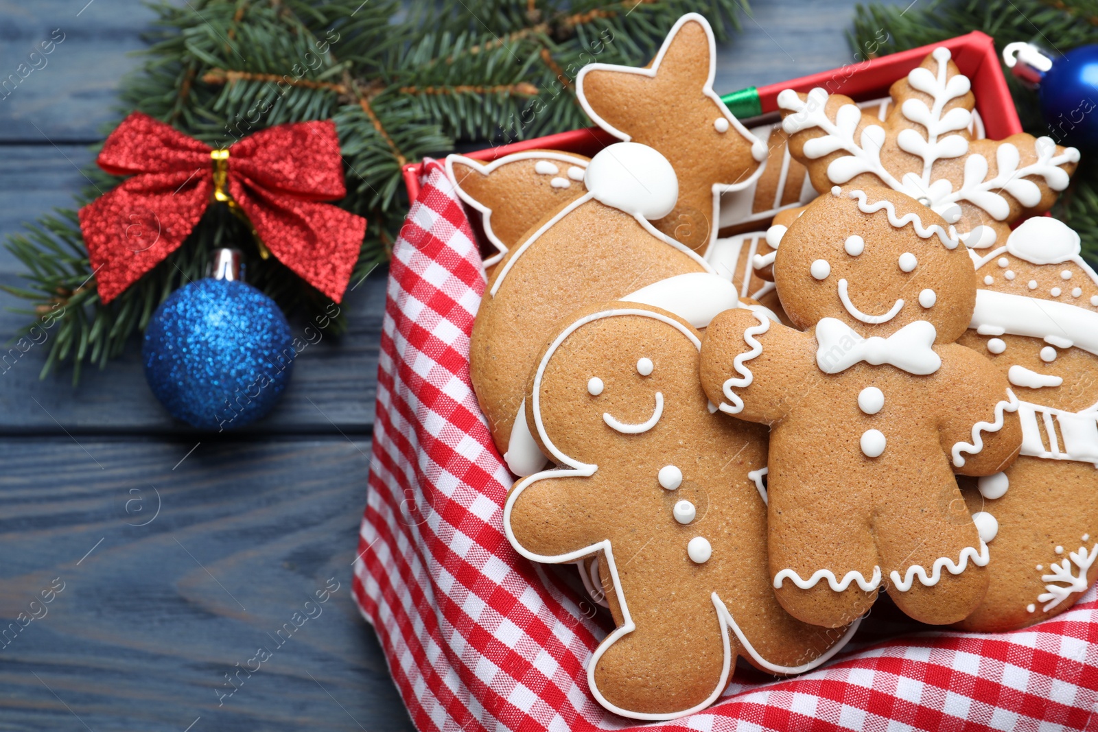 Photo of Decorated Christmas cookies on blue wooden table, closeup