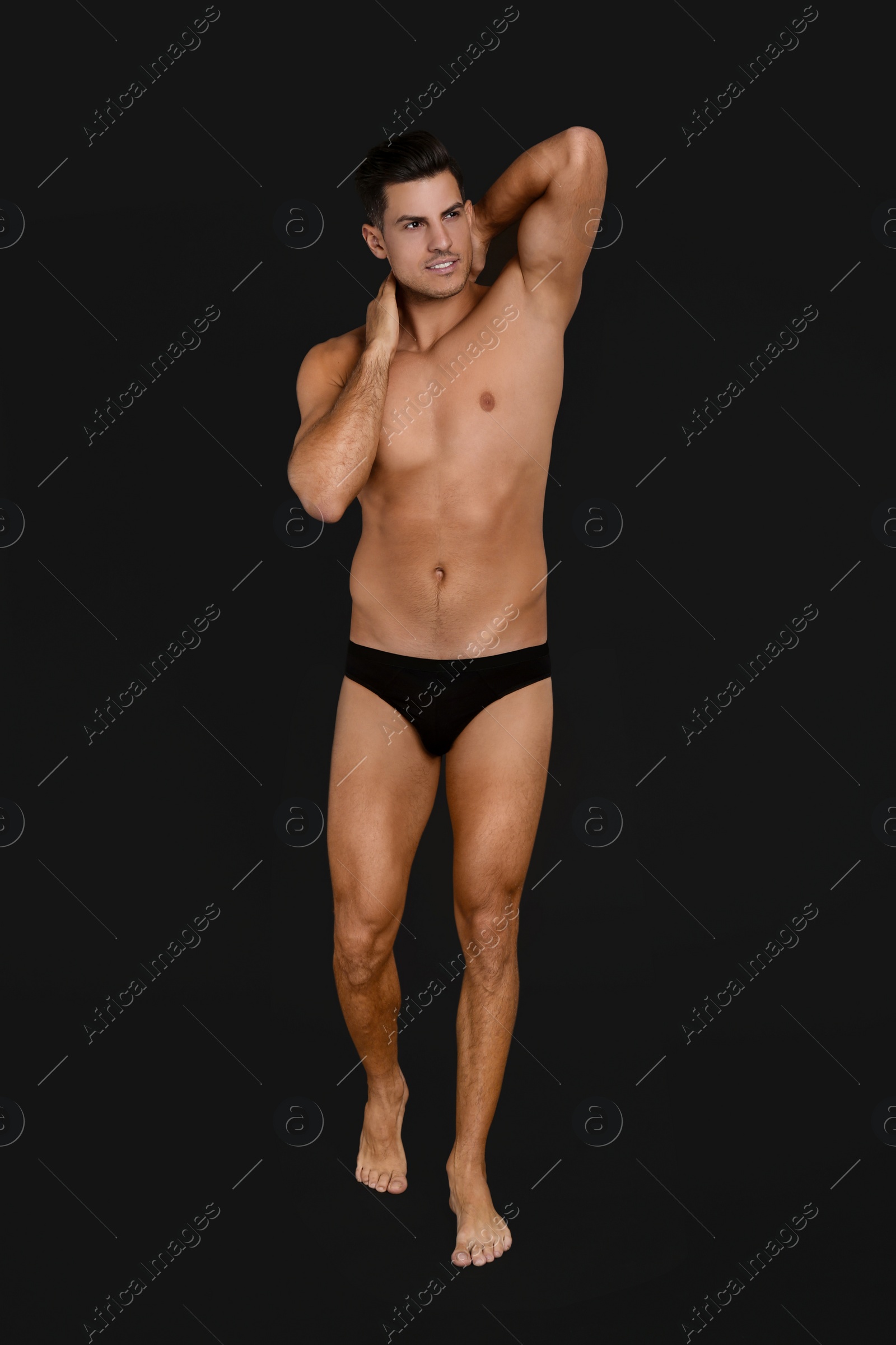 Photo of Handsome man in underwear on black background