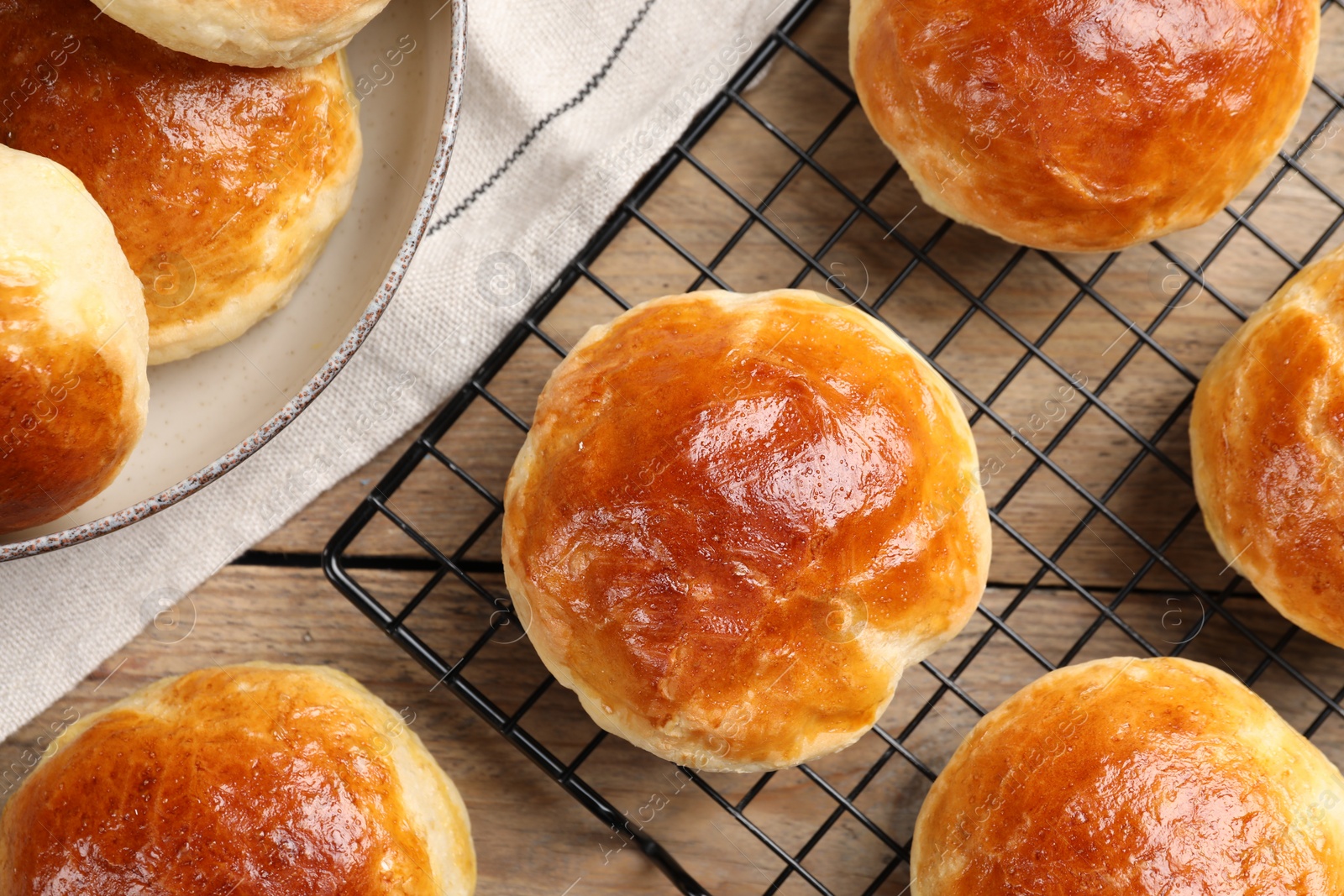 Photo of Tasty scones prepared on soda water on wooden table, flat lay