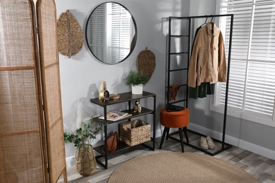 Stylish room interior with console table and beautiful decor elements