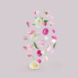 Image of Different beautiful flowers flying on light grey background