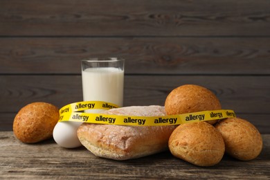 Photo of Allergenic food. Different fresh products with tape on wooden table