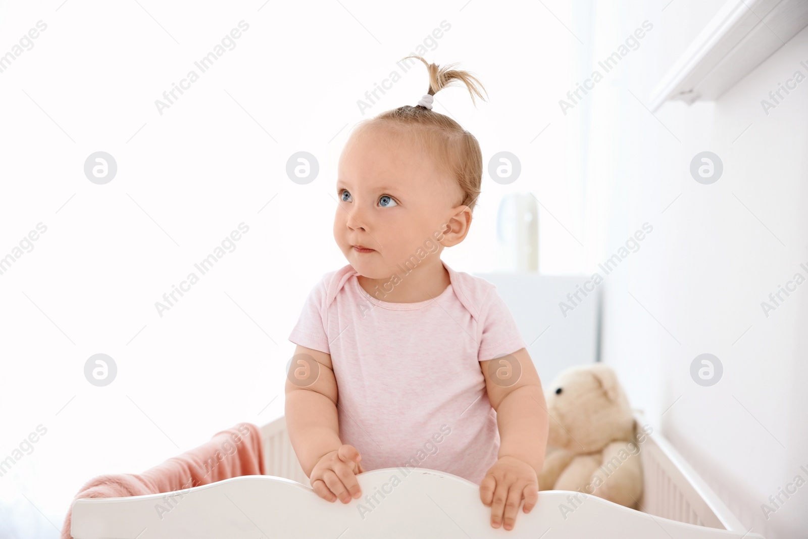 Photo of Adorable baby girl in her crib at home