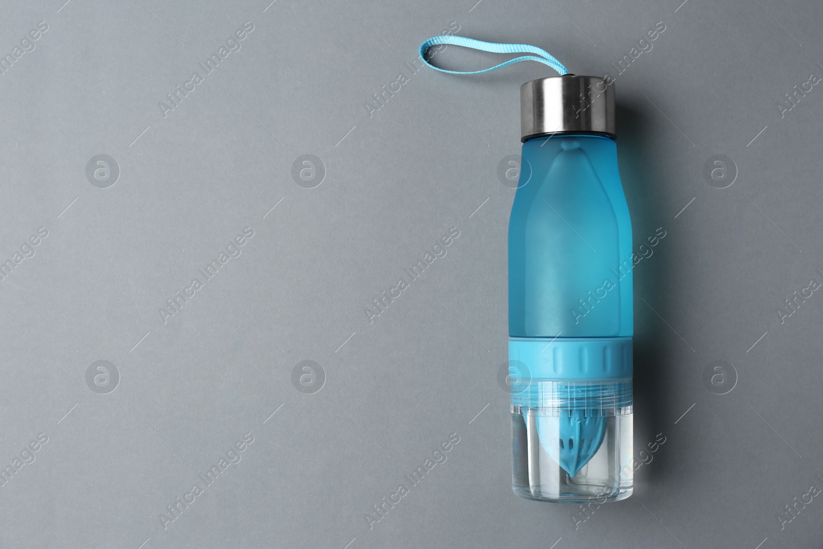 Photo of Sport bottle with space for text on color background, top view