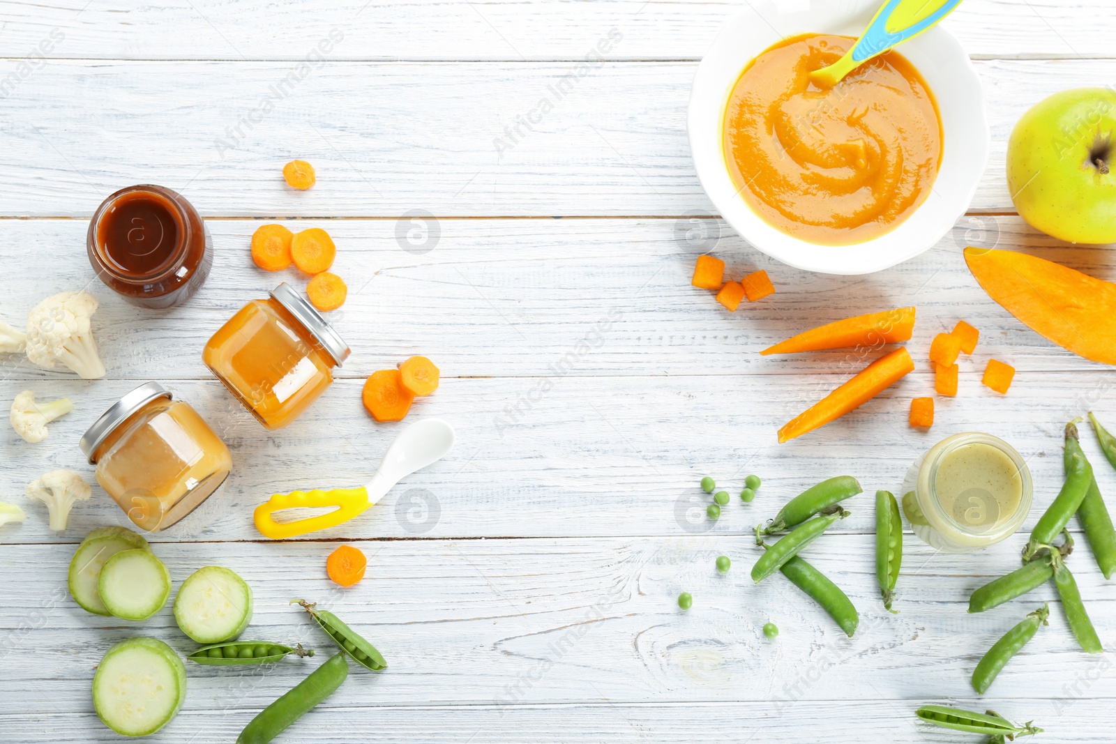 Photo of Flat lay composition with baby food and ingredients on wooden background