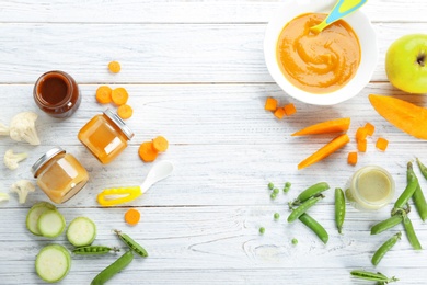Photo of Flat lay composition with baby food and ingredients on wooden background