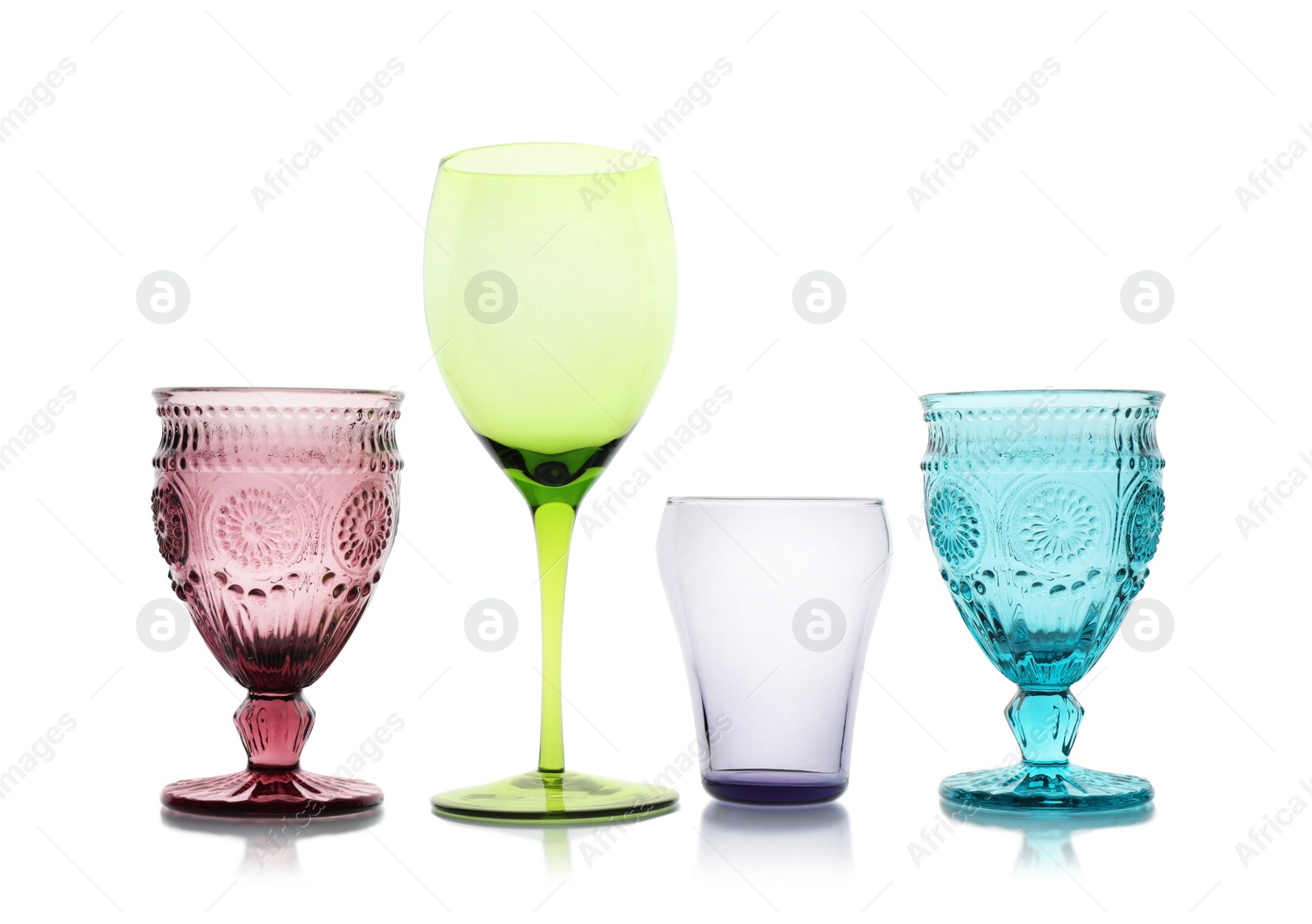 Photo of Set of colorful empty glasses on white background