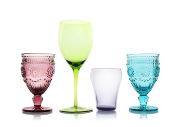 Photo of Set of colorful empty glasses on white background