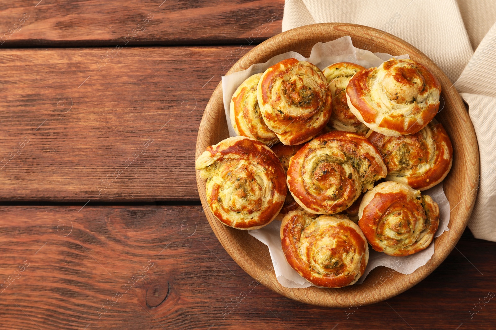 Photo of Fresh delicious puff pastry with tasty filling on wooden table, top view. Space for text