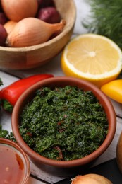 Photo of Fresh marinades and ingredients on white table, closeup