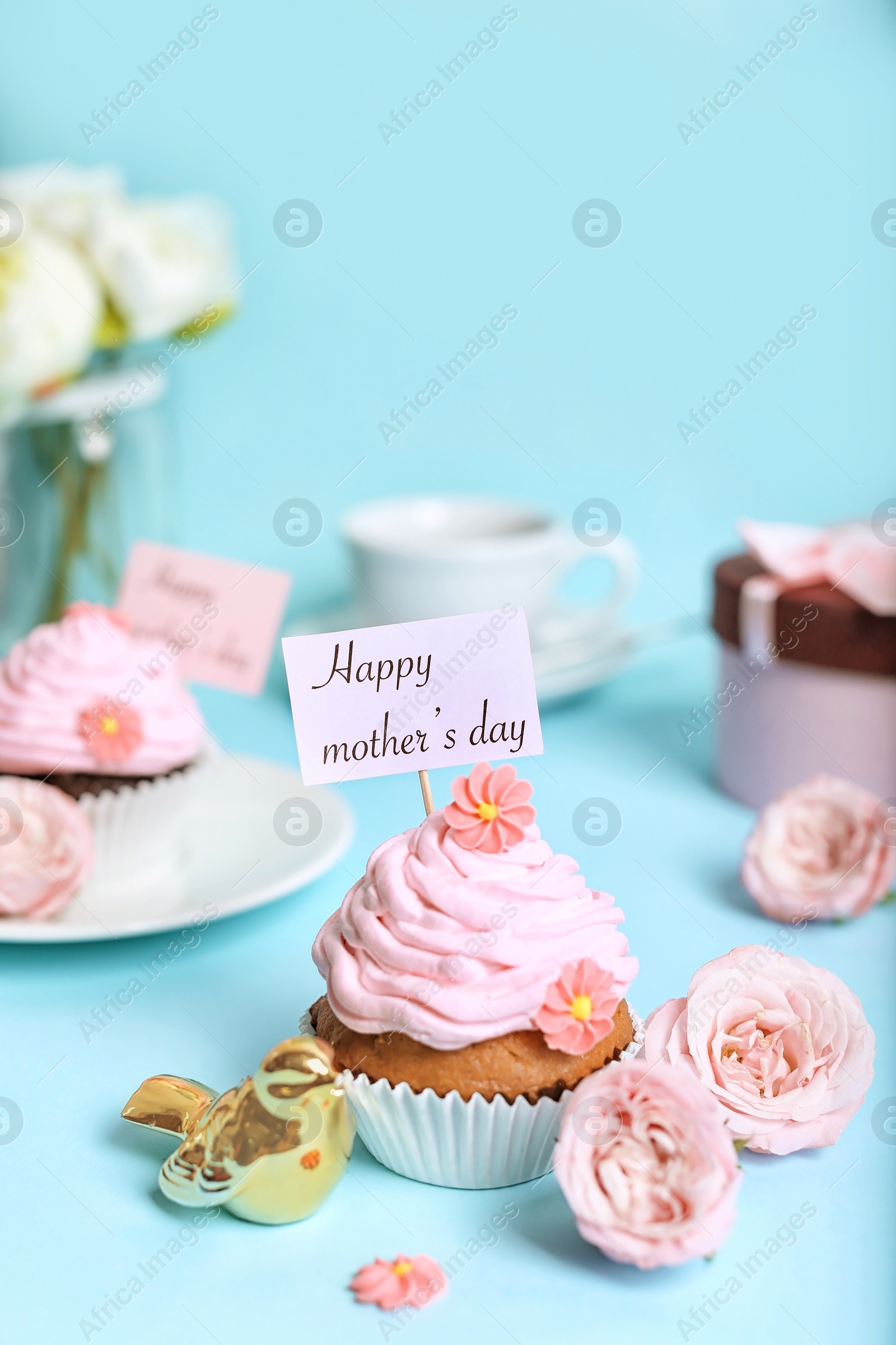 Photo of Festive surprise with tasty treat for Mother's Day on color background