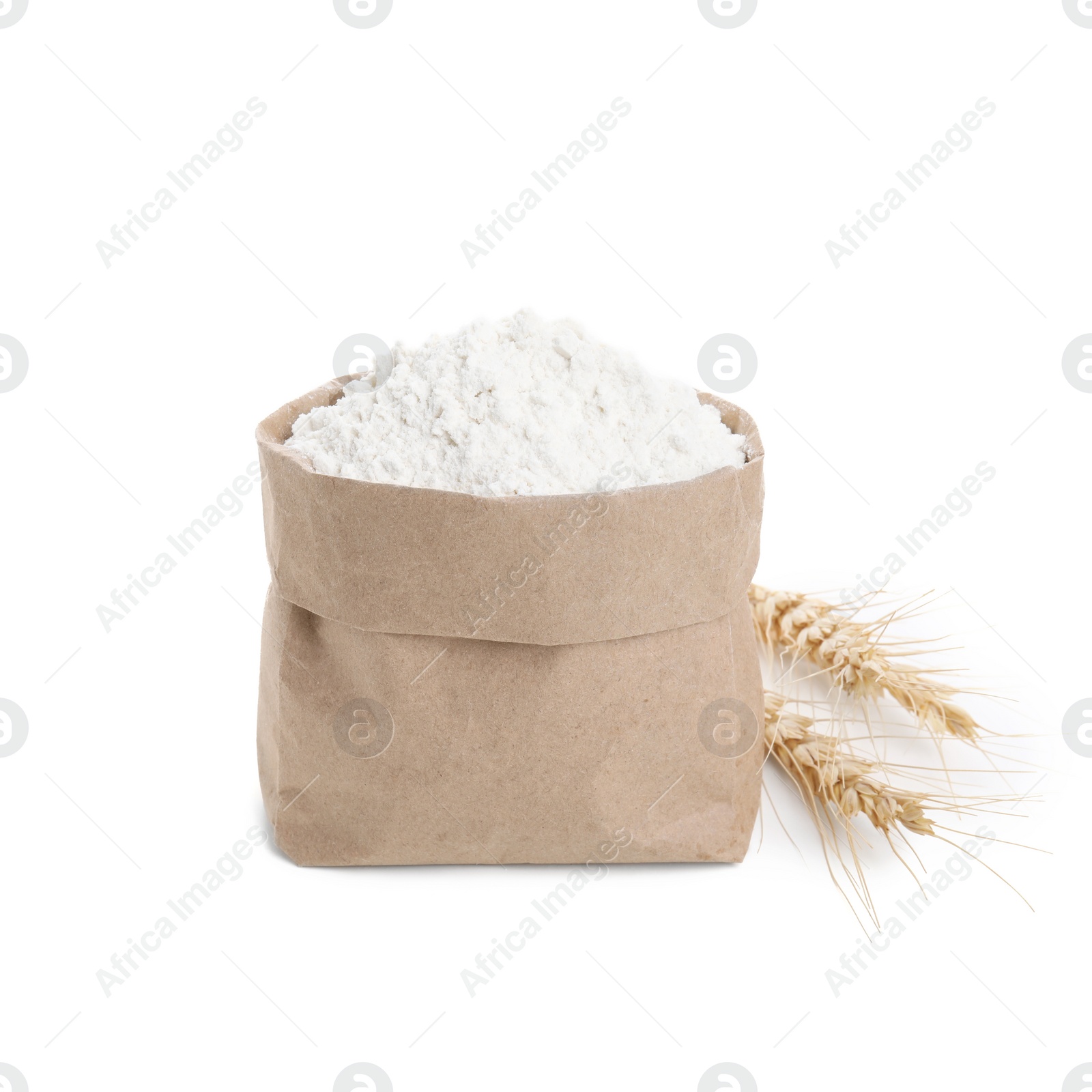 Photo of Paper bag with wheat flour and spikes isolated on white