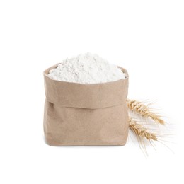 Photo of Paper bag with wheat flour and spikes isolated on white