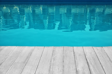 Modern swimming pool outdoors on sunny day. Space for text