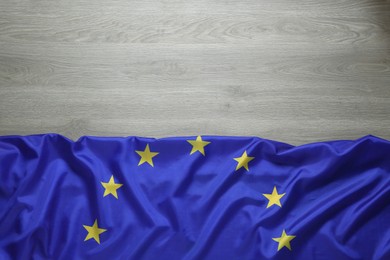 Flag of European Union on wooden background, top view. Space for text