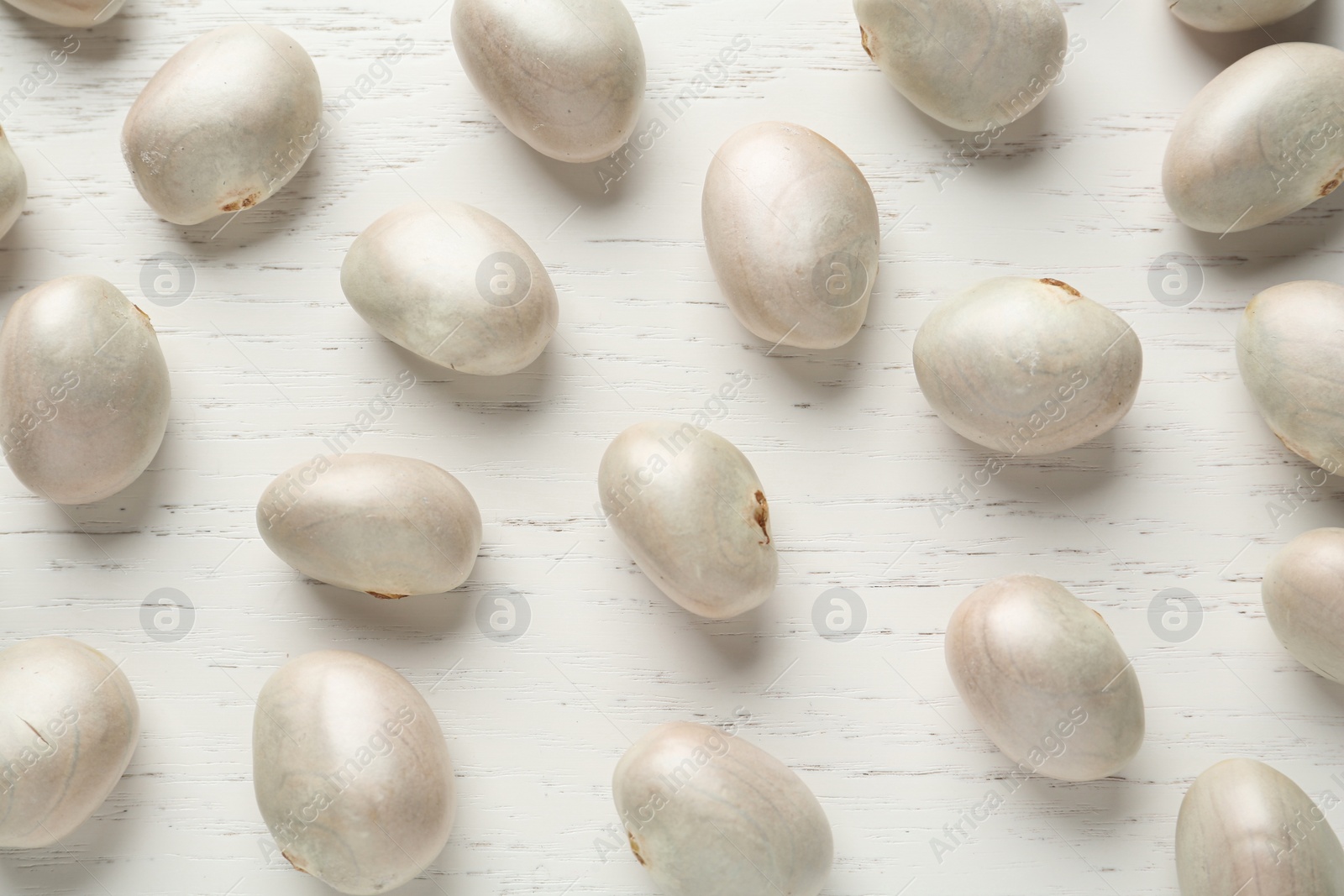 Photo of Raw jackfruit seeds on white wooden table, flat lay