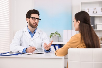 Photo of Doctor consulting patient during appointment in clinic