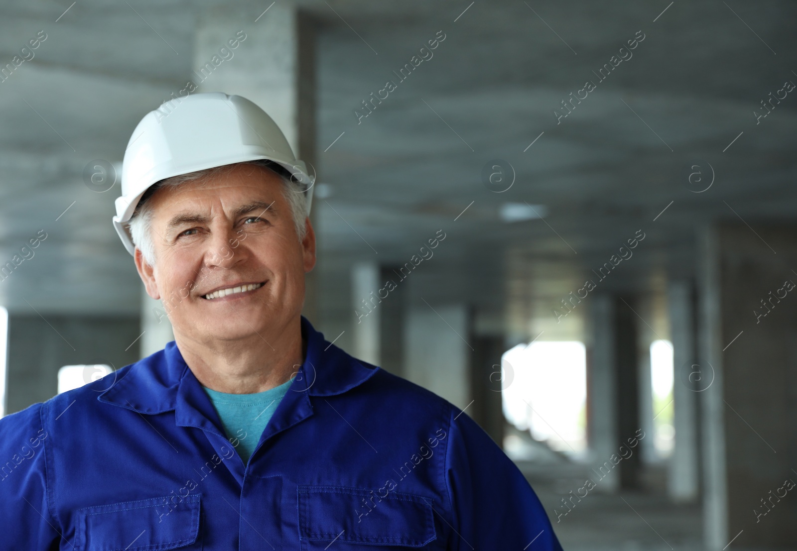 Photo of Professional builder at construction site, space for text. Safety equipment