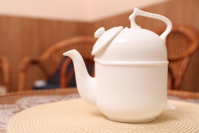 Photo of White teapot for traditional ceremony on table