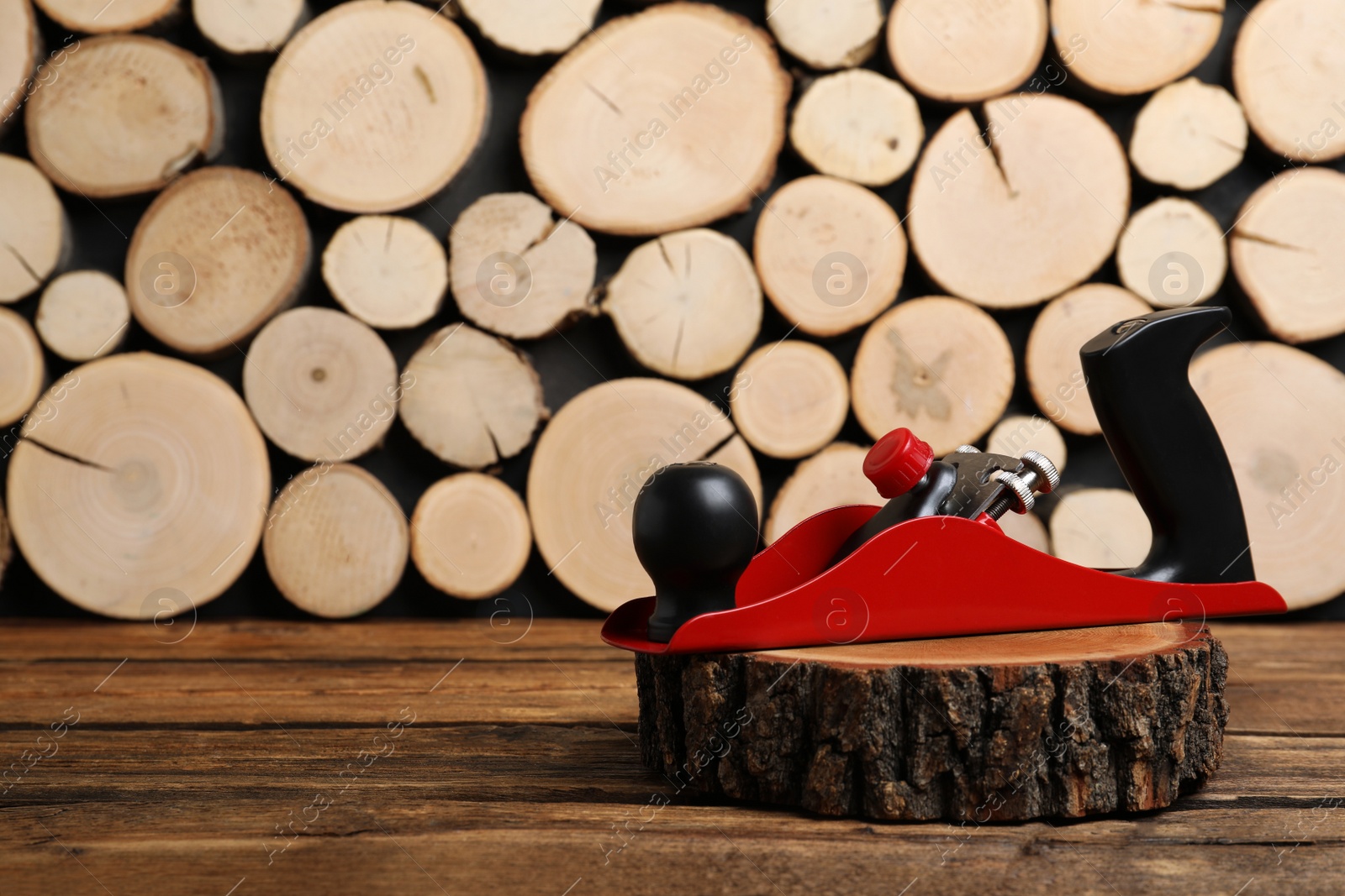 Photo of Wooden cut with jack plane on table, space for text. Carpenter's tool