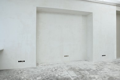 Empty white wall in room prepared for renovation