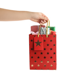 Photo of Woman holding shopping paper bag with presents on white background, closeup