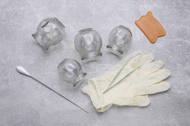 Cupping set on grey table, flat lay