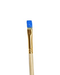 Photo of Brush with blue paint on white background