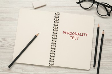 Image of Notebook with text Personality Test on white wooden table, flat lay