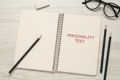 Notebook with text Personality Test on white wooden table, flat lay