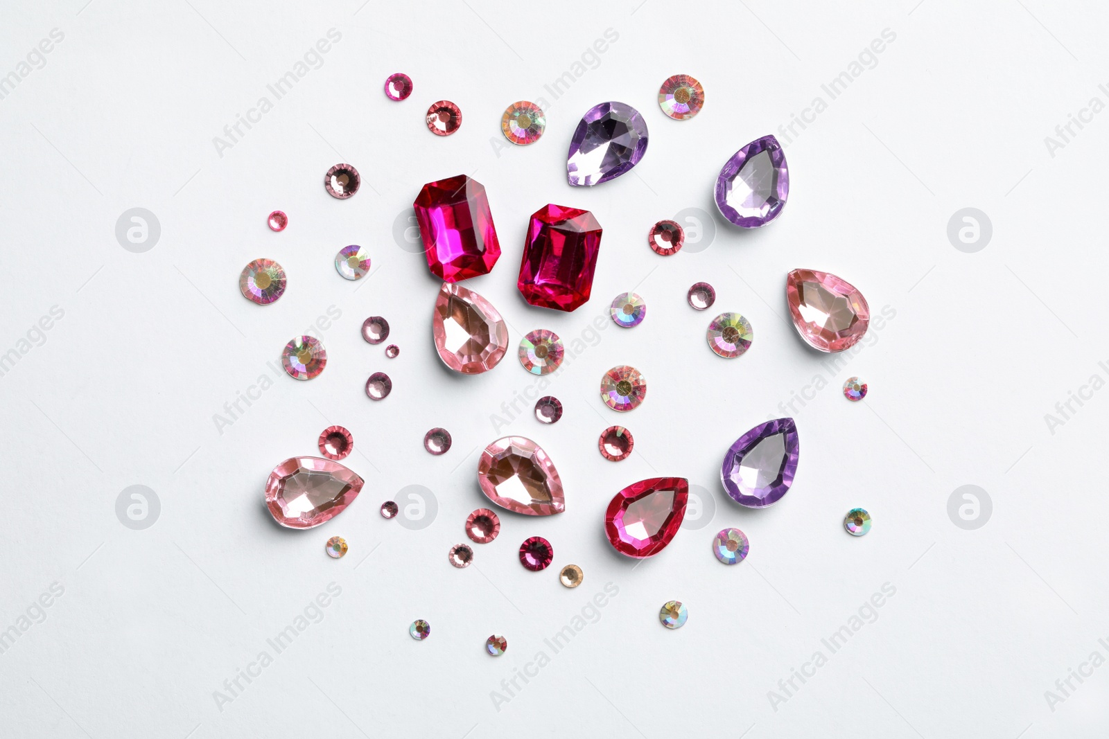 Image of Different beautiful gemstones on white background, top view