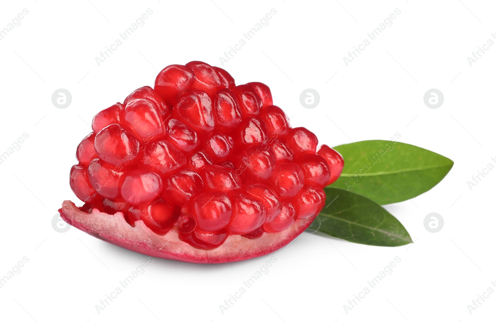Photo of Piece of ripe juicy pomegranate and green leaves on white background