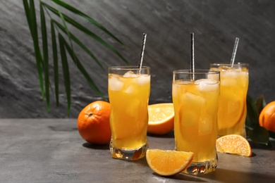 Delicious orange soda water on grey table