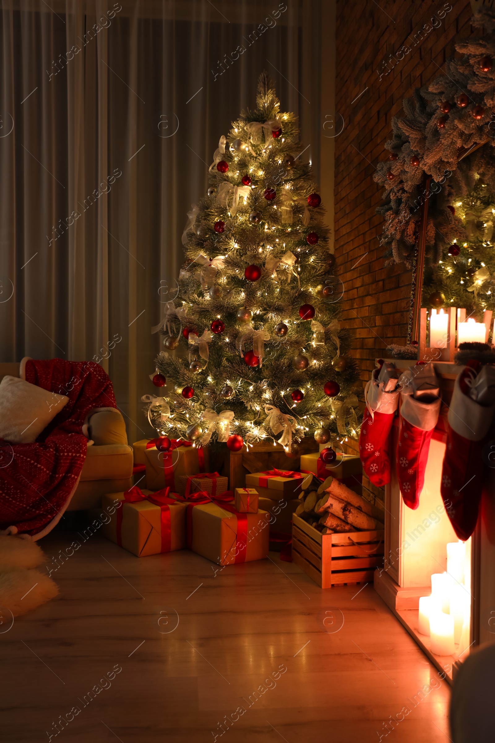 Photo of Stylish room interior with beautiful Christmas tree in evening