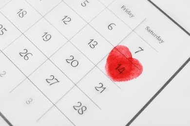 Valentine's day marked with red fingerprints on calendar sheet