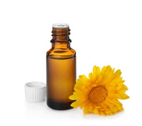 Photo of Bottle of essential oil and flower on white background