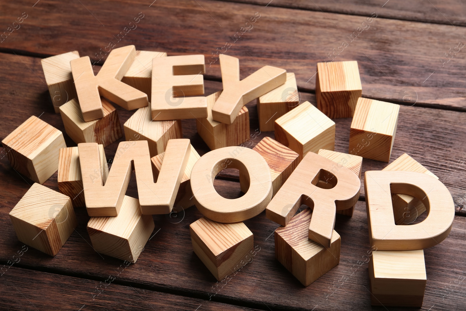 Photo of Word KEYWORD made of letters and cubes on wooden background
