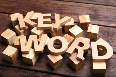 Photo of Word KEYWORD made of letters and cubes on wooden background