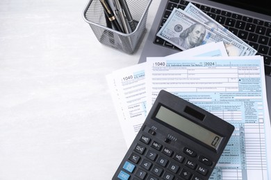 Tax accounting. Calculator, documents, money and stationery on light grey table, top view. Space for text