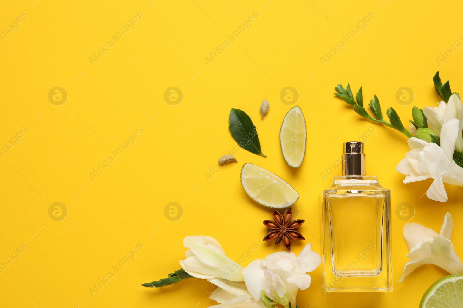 Photo of Flat lay composition with bottle of perfume and fresh citrus fruits on yellow background. Space for text