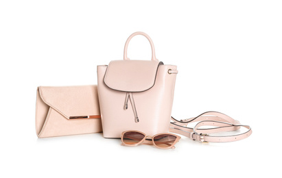 Photo of Different stylish woman's bags and sunglasses isolated on white