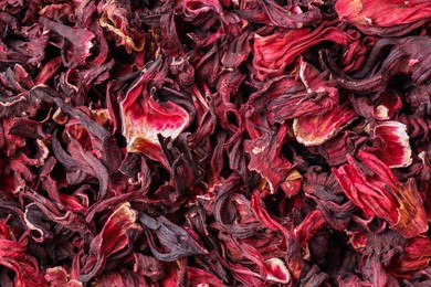 Dry hibiscus tea as background, top view