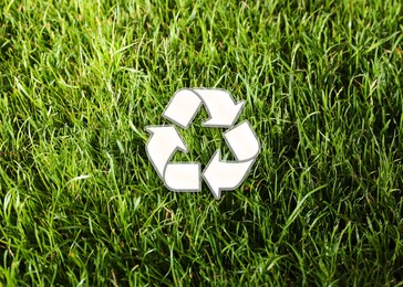 Image of Green grass and illustration of recycling symbol