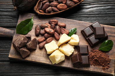 Photo of Flat lay composition with organic cocoa butter on wooden table