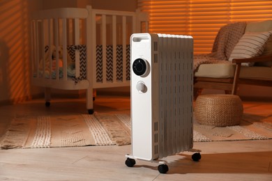 Modern portable electric heater in child room
