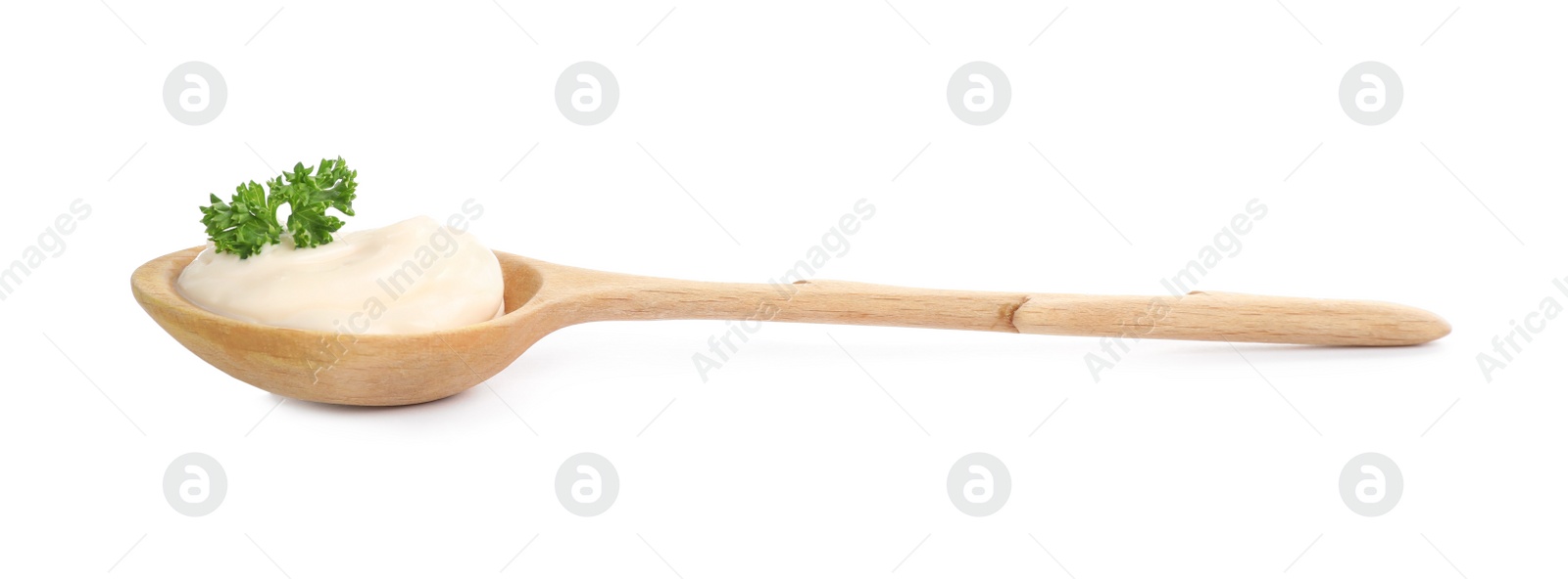 Photo of Wooden spoon with tasty mayonnaise and parsley isolated on white